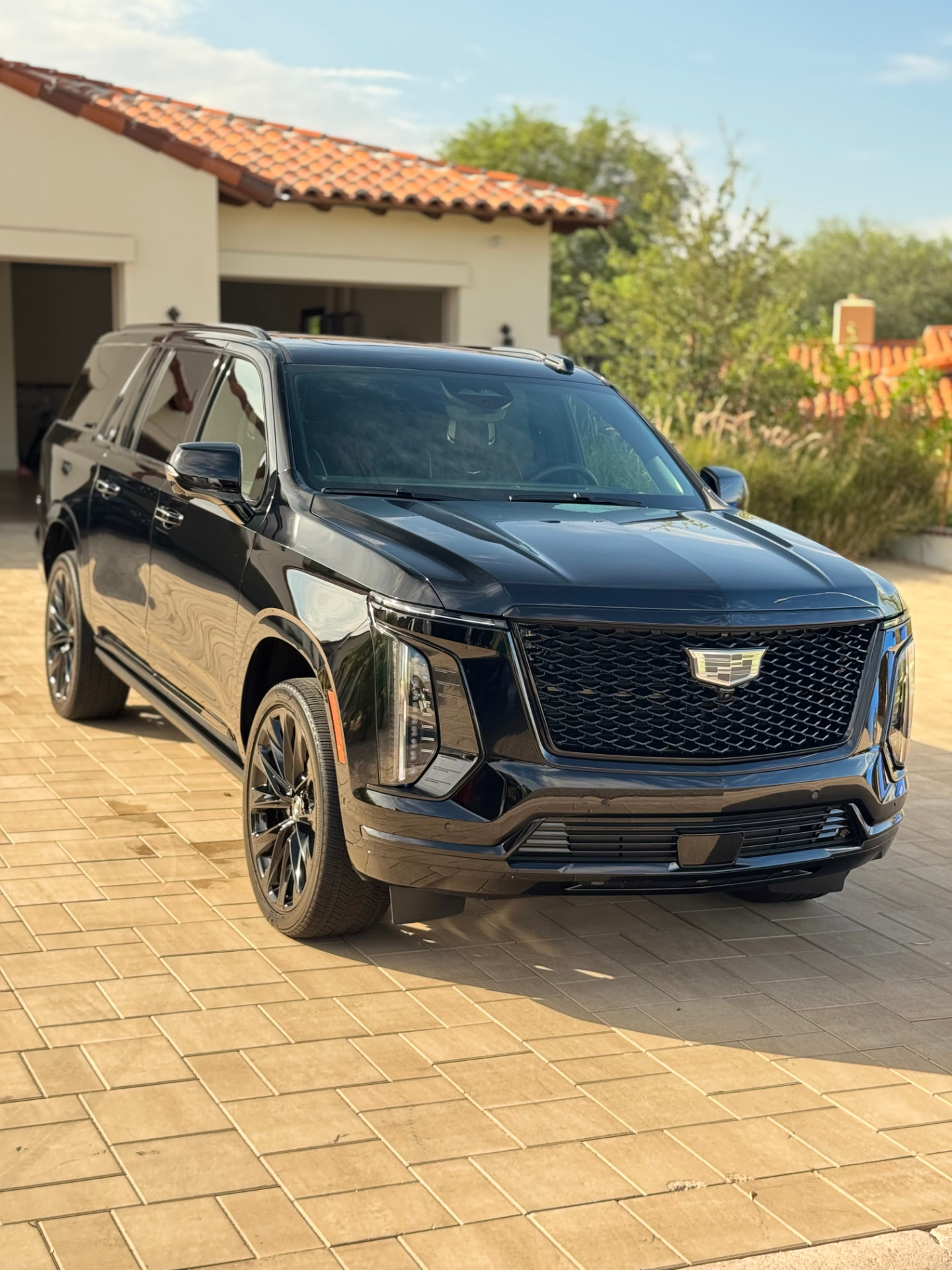 Detailed black Cadillac Escalade in a Valley driveway